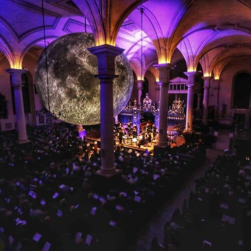 Event at Sinfonia Viva with purple lighting and a crowd sat watching