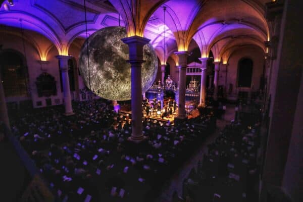 Event at Sinfonia Viva from above with purple lighting and a crowd sat watching