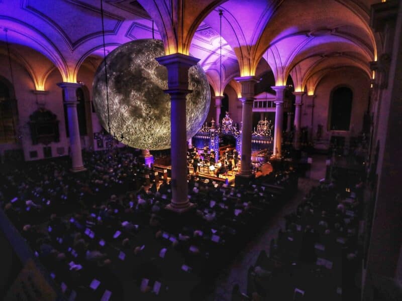 Event at Sinfonia Viva from above with purple lighting and a crowd sat watching