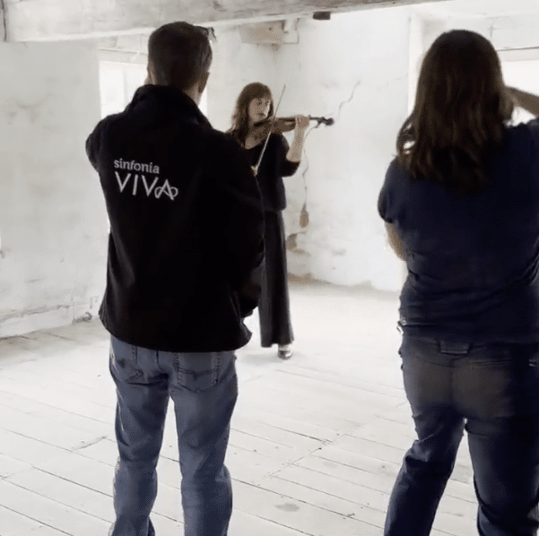 Staff from Sinfonia Viva taking pictures of SophiaeRosa playing the violin