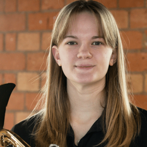 A photo of Sarah Pennington in Derby's Museum of Making. She's french horn as she is the section principal horn player for Sinfonia Viva