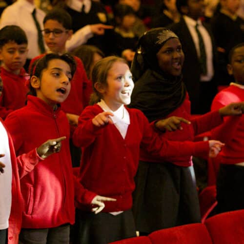 school children singing in a choir