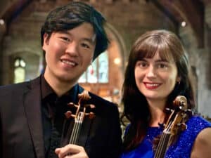 Violinists Peter Liang and Sophie Rosa pictured in a church
