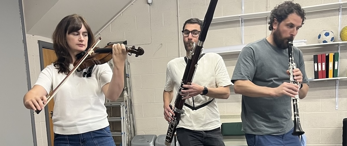 Picture shows three musicians - playing violin, clarinet and bassoon - rehearsing for the performance of the Leap Year children's show