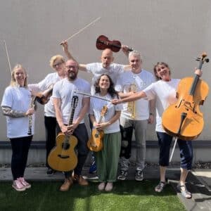 Seven Sinfonia Viva musicians pose for a group photo with their instruments